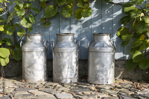 three churns on a farm photo