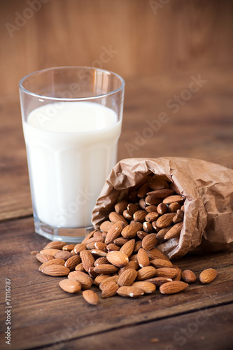 Almond milk in glass with almonds
