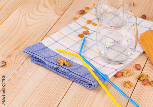 Glasses and drinking straws on tablecloth.