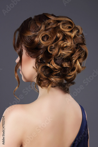Rear View of Woman's Festive Hairstyle. Waved Hairs