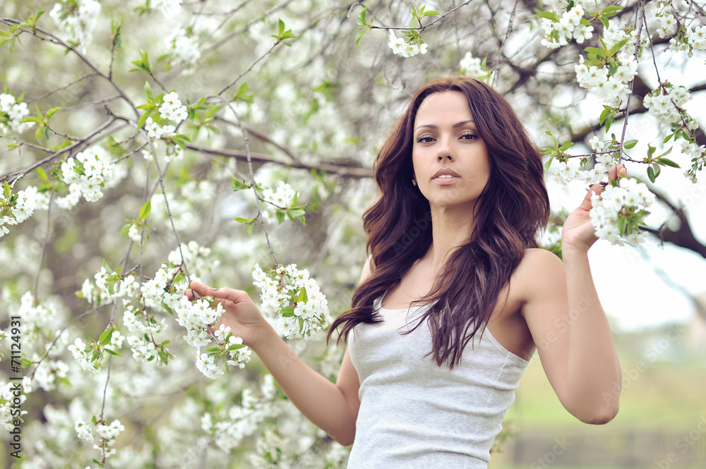 Beautiful young brunette woman in blooming garden Beautiful young brunette woman in blooming garden