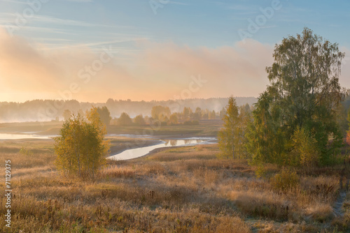 Early autumn morning, the sunrise, the fog over the river