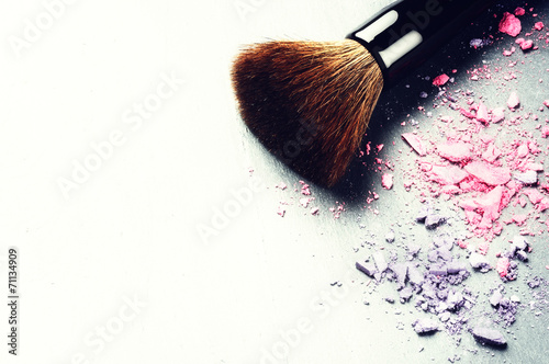 Makeup brush and crushed eyeshadows