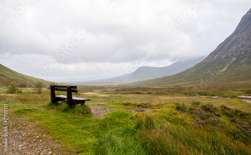 park bench overlooking scenery at glencoe, scotland