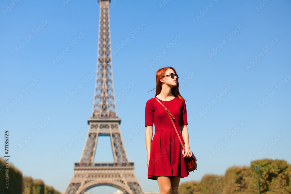 Beautifu girl in Paris with Eiffel tower on background.