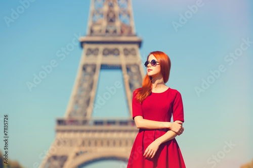 Beautifu girl in Paris with Eiffel tower on background.