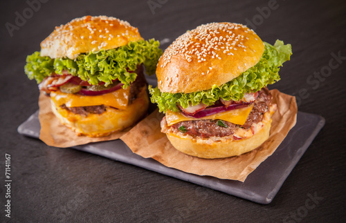 Fresh hamburgers served on black stone