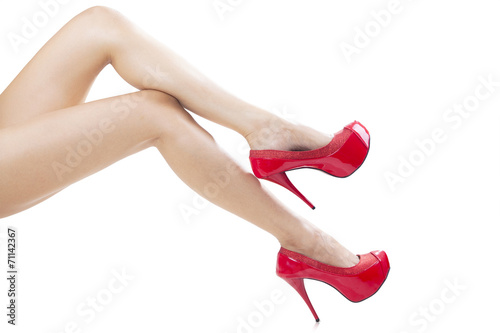 Smooth female legs wearing high heels