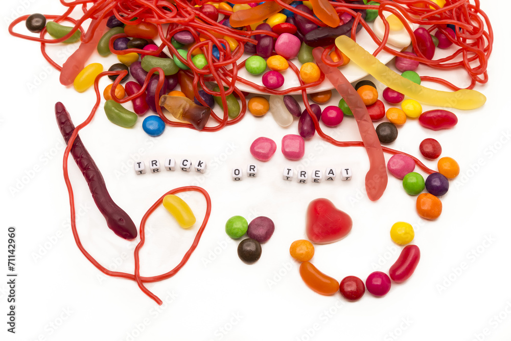 Trick or Treat candy spilling out onto white background Trick or Treat candy spilling out onto white background