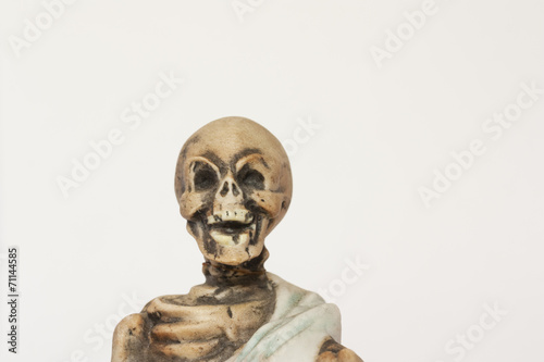 Skeleton figurine wearing blue shroud