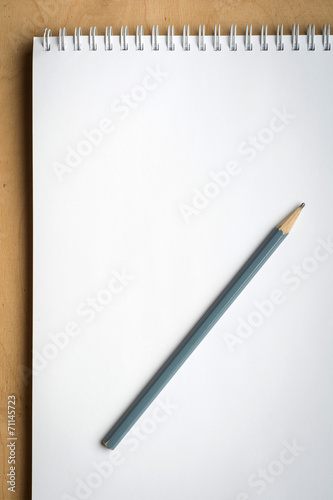 notebook with pencile on a wood close up photo