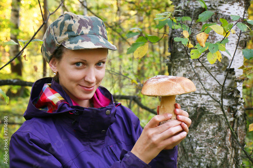 girl collect cep boletus on forest