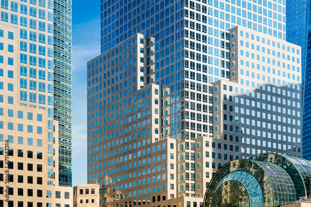 Obraz premium Detail of skyscrapers facade with windows in blue and yellow