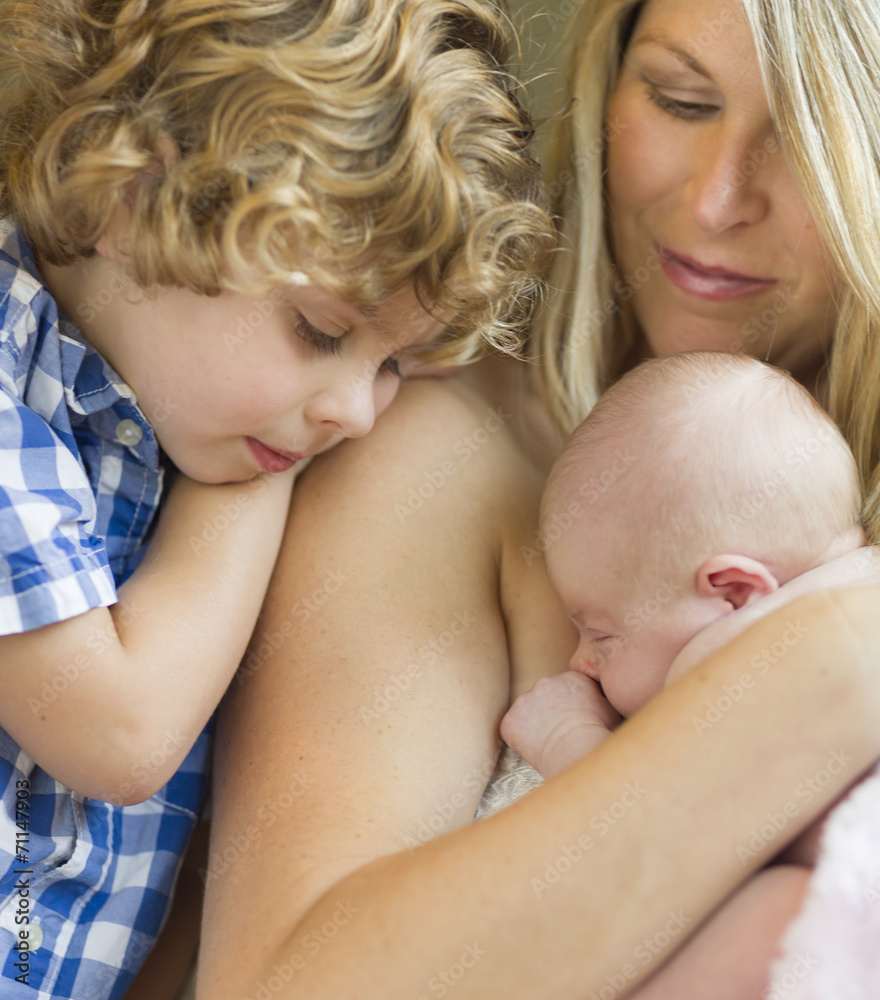 Young Mother Holds Newborn Baby Girl as Brother Looks On Young Mother Holds Newborn Baby Girl as Brother Looks On