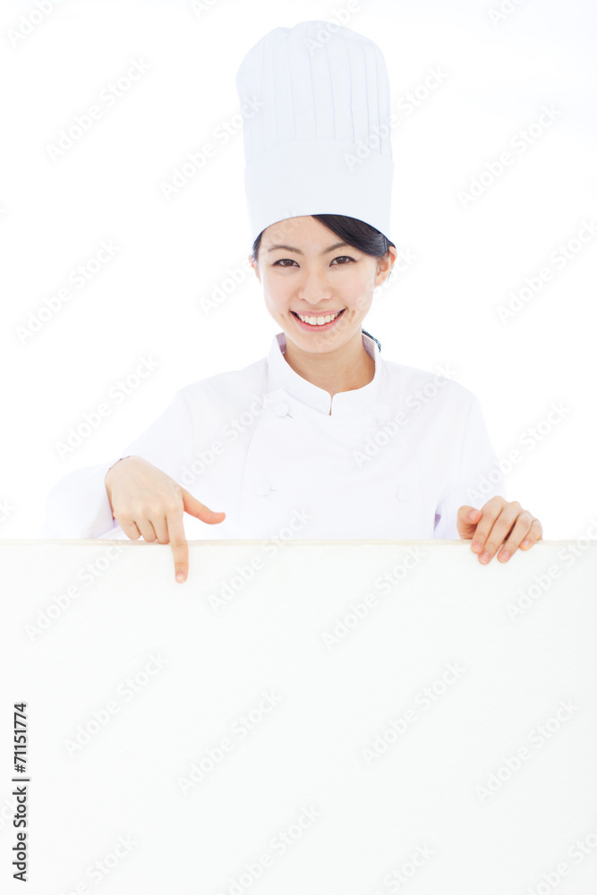 看板を指差す女性シェフ 看板を指差す女性シェフ