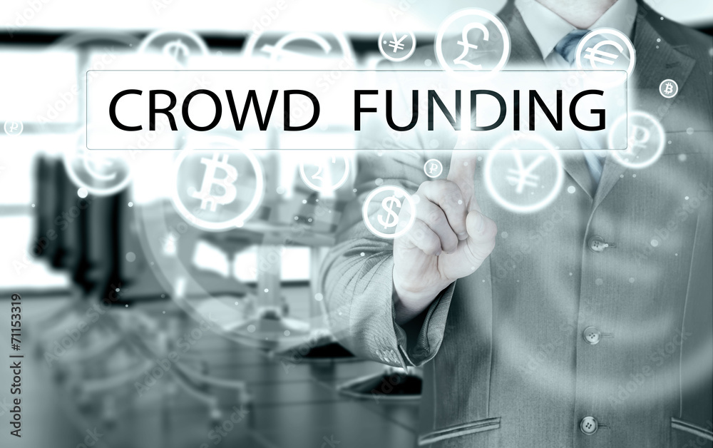 Businessman pushes virtual crowd funding button Businessman pushes virtual crowd funding button