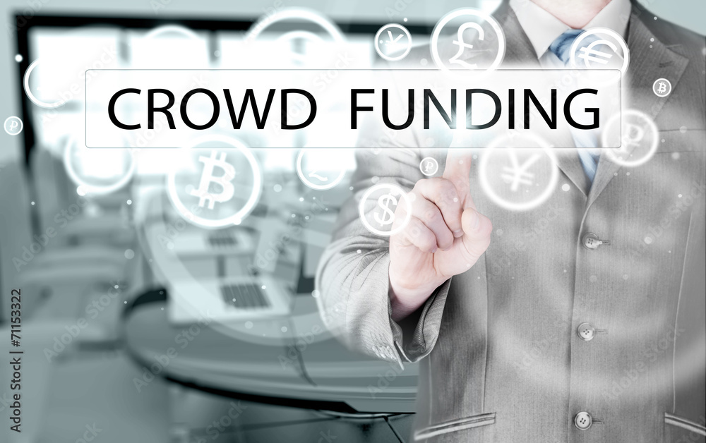 Businessman pushes virtual crowd funding button Businessman pushes virtual crowd funding button