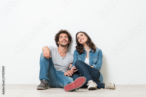 Happy Young Couple Looking Up photo