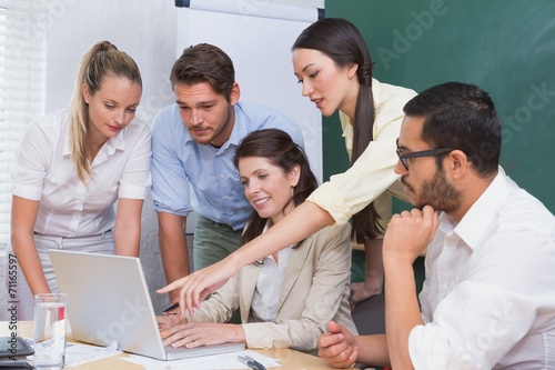 Businesswoman pointing at a laptop during the meeting