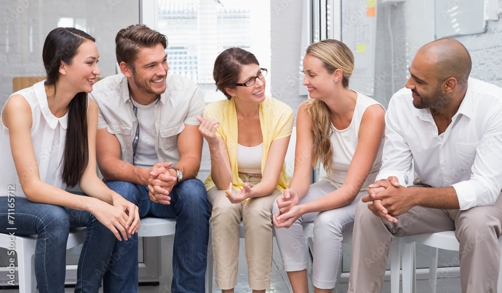 Business people talking and working together on chairs Business people talking and working together on chairs