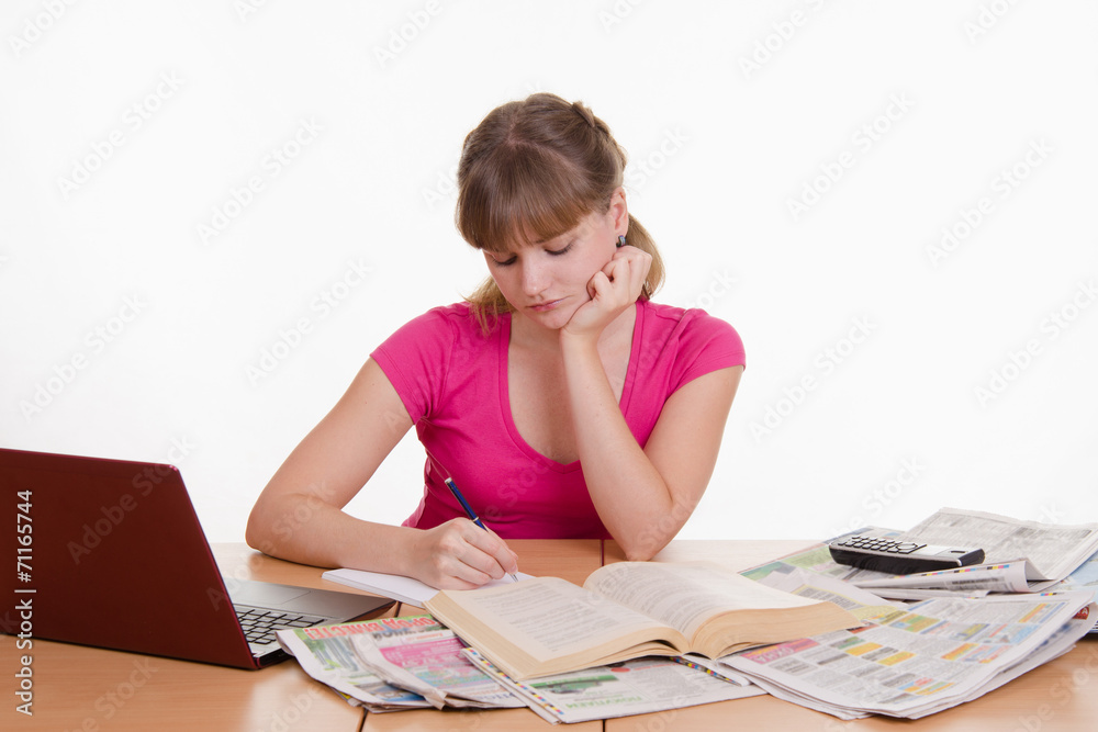 The girl writes a phone number to notebook The girl writes a phone number to notebook