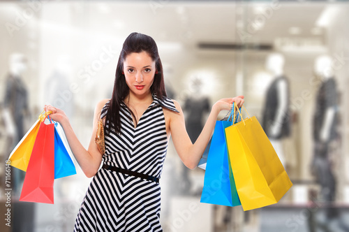 Young woman holding shopping bags