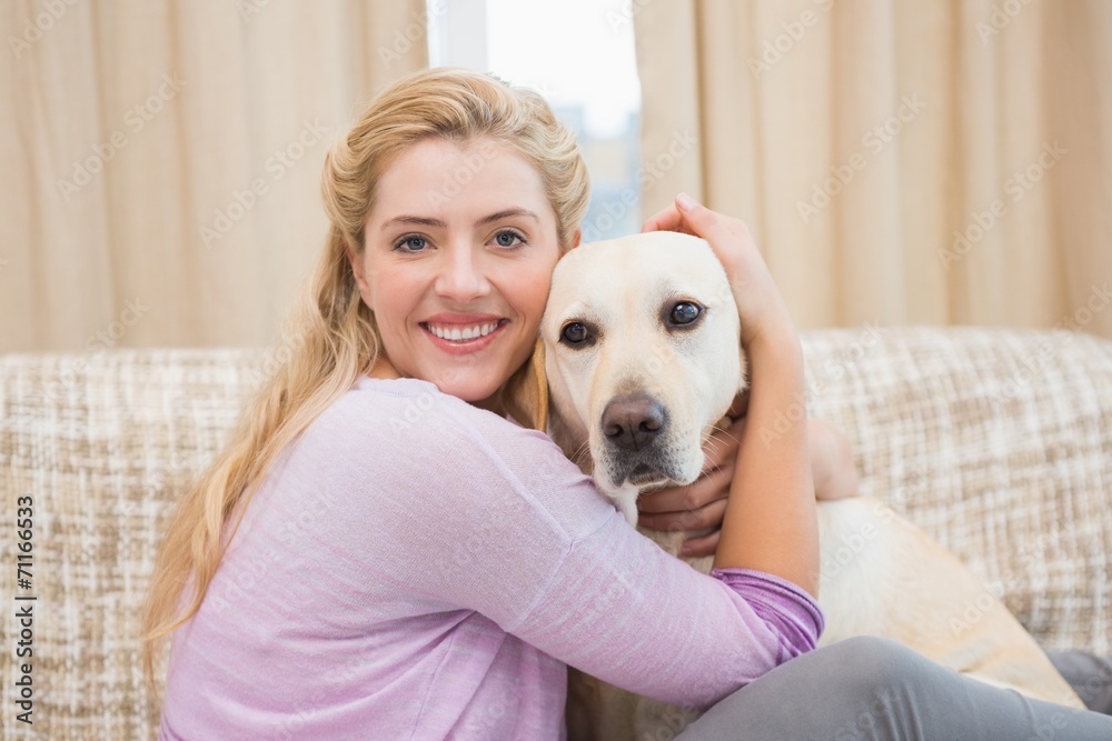 Beautiful blonde on couch with pet dog Beautiful blonde on couch with pet dog
