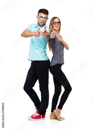 Happy couple smiling holding thumb up gesture, beautiful young m