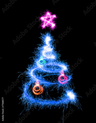 Christmas tree made by sparkler on a black