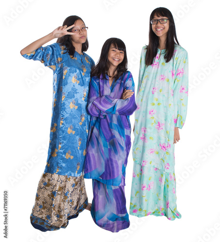 Malay teenage sisters in traditional attire 
