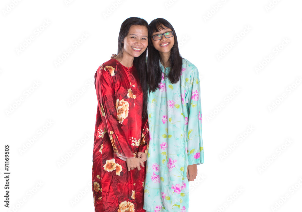 Asian Malay mother and daughter in traditional dress 