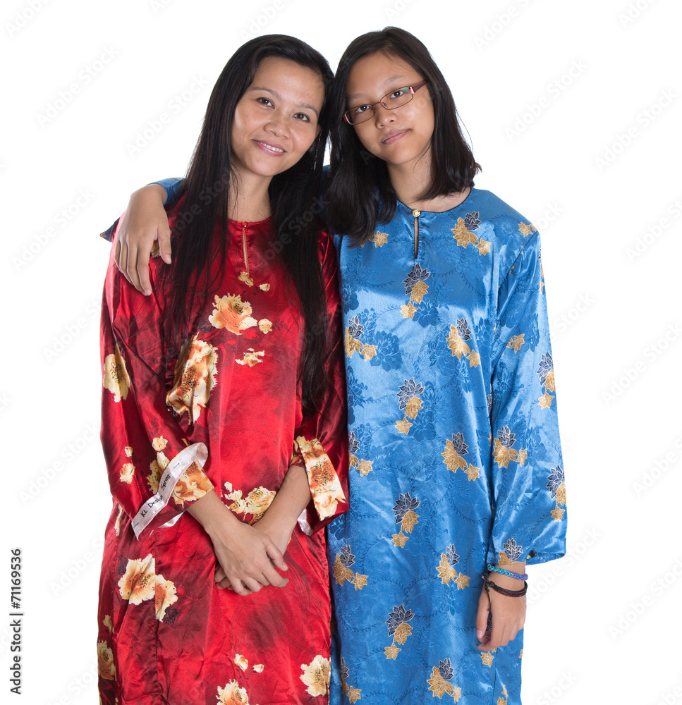 Asian Malay mother and daughter in traditional dress Asian Malay mother and daughter in traditional dress
