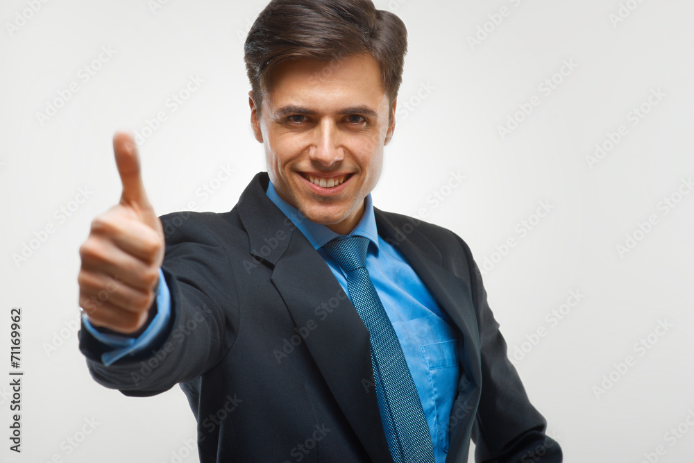 Businessman showing thumbs up sign on white background Businessman showing thumbs up sign on white background