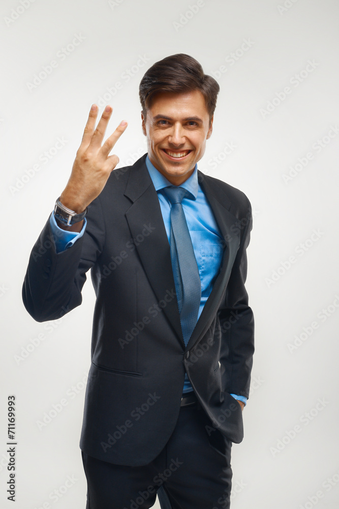 Closeup of a young business man showing showing three number. Closeup of a young business man showing showing three number.