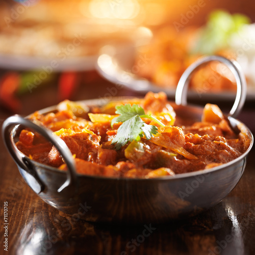 indian chicken vindaloo curry in balti dish with lens flare photo