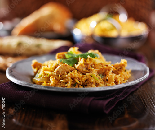 indian food - chicken biryana on metal plate