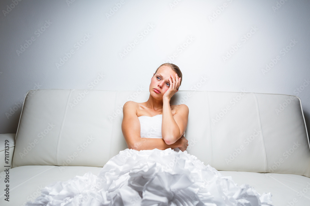 Sad bride crying sitting on a sofa Sad bride crying sitting on a sofa
