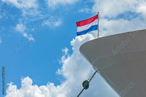 Anchored cruise boat with a Dutch Flag