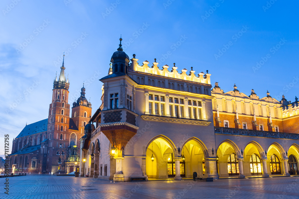Sukiennice and St. Mary's Church at night in Krakow, Poland.