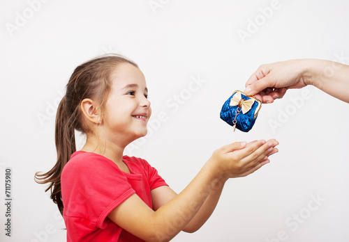 mother gives the purse to a little girl