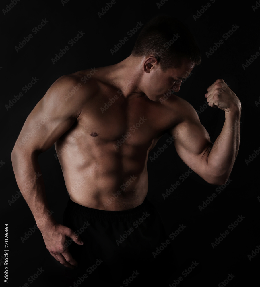 Sexy muscular man on dark background Sexy muscular man on dark background