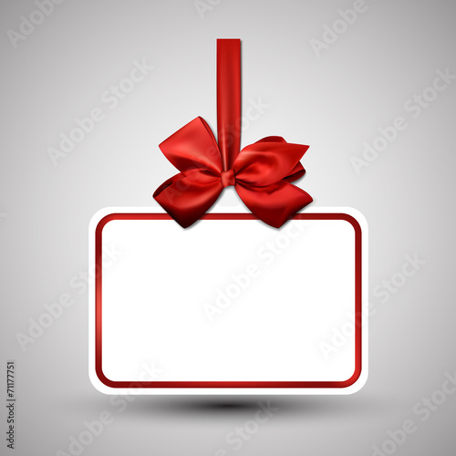 White paper gift card with red satin bow.