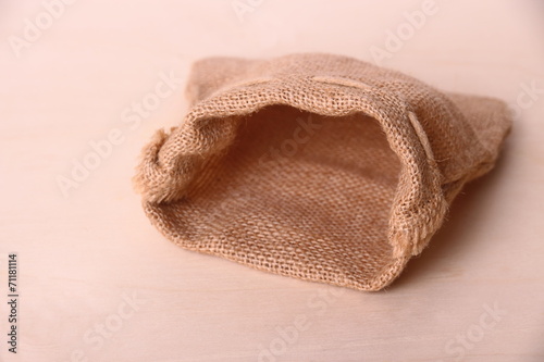 Empty jute sack on wood background