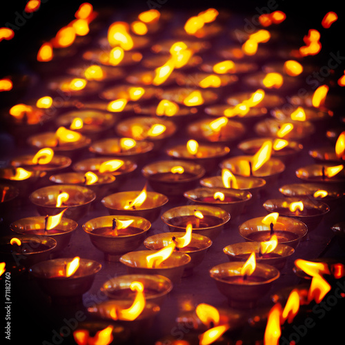 Burning candles in Buddhist temple, McLeod Ganj photo