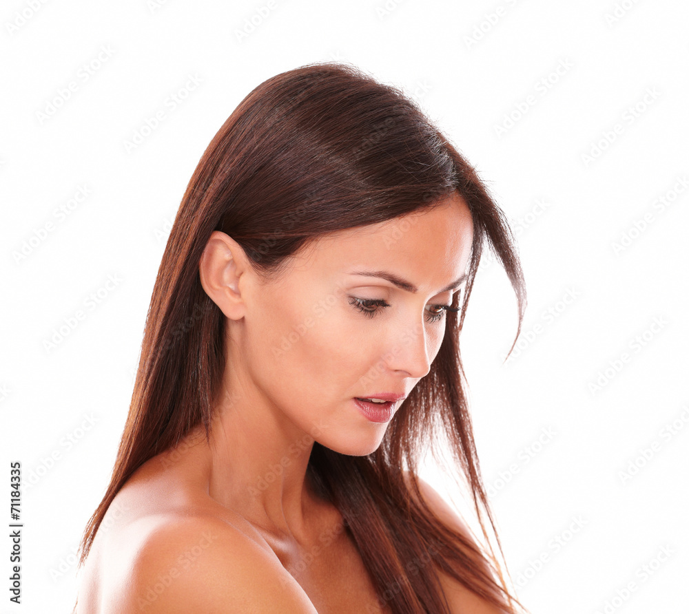 Serious young woman with brown hair looking down Serious young woman with brown hair looking down