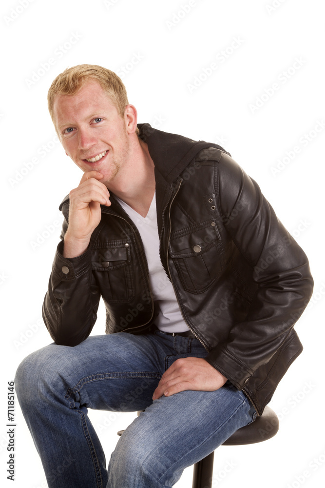 man black jacket sit hand on chin smile man black jacket sit hand on chin smile