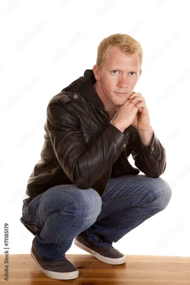 man in black jacket looking down low man in black jacket looking down low