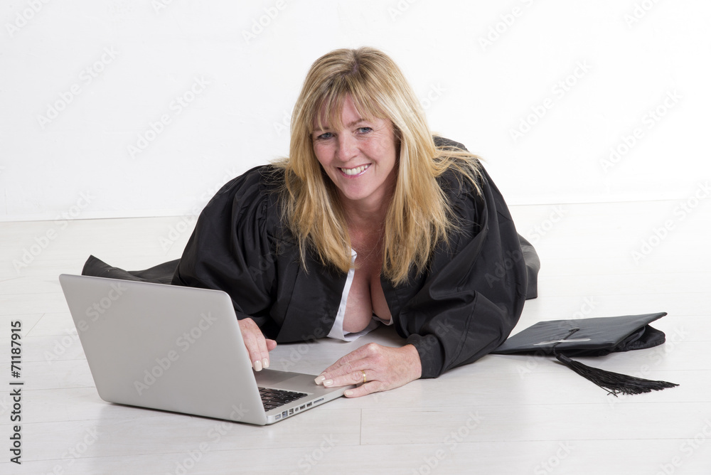 Mature university student laying on floor studying Mature university student laying on floor studying
