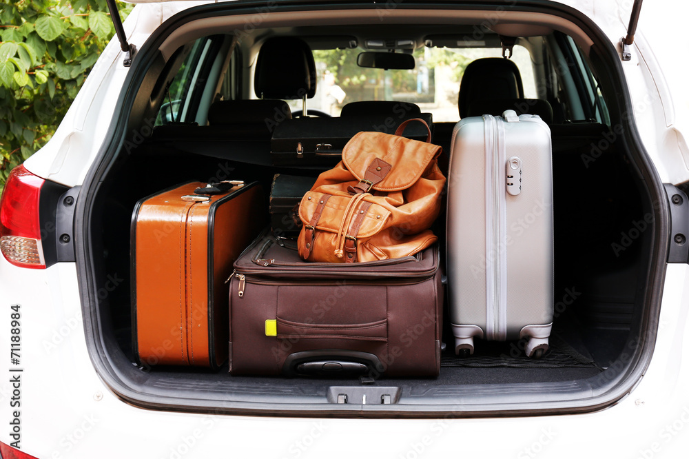 Suitcases and bags in trunk of car ready to depart for holidays Suitcases and bags in trunk of car ready to depart for holidays