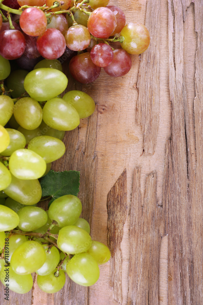 Bunches of grapes on wooden background Bunches of grapes on wooden background